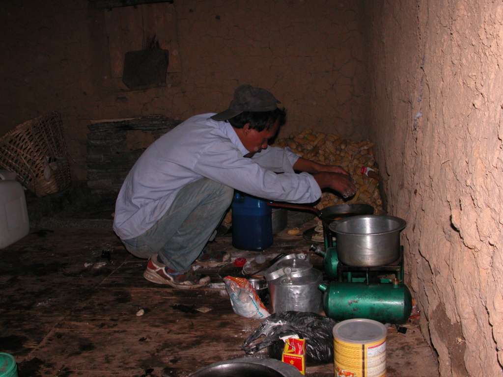 Manaslu 05 01 Cooking Breakfast We camped in a farmer�s field in Ekle Bhatti (1600m) and were up before sunrise the next morning with Schandra cooking breakfast.